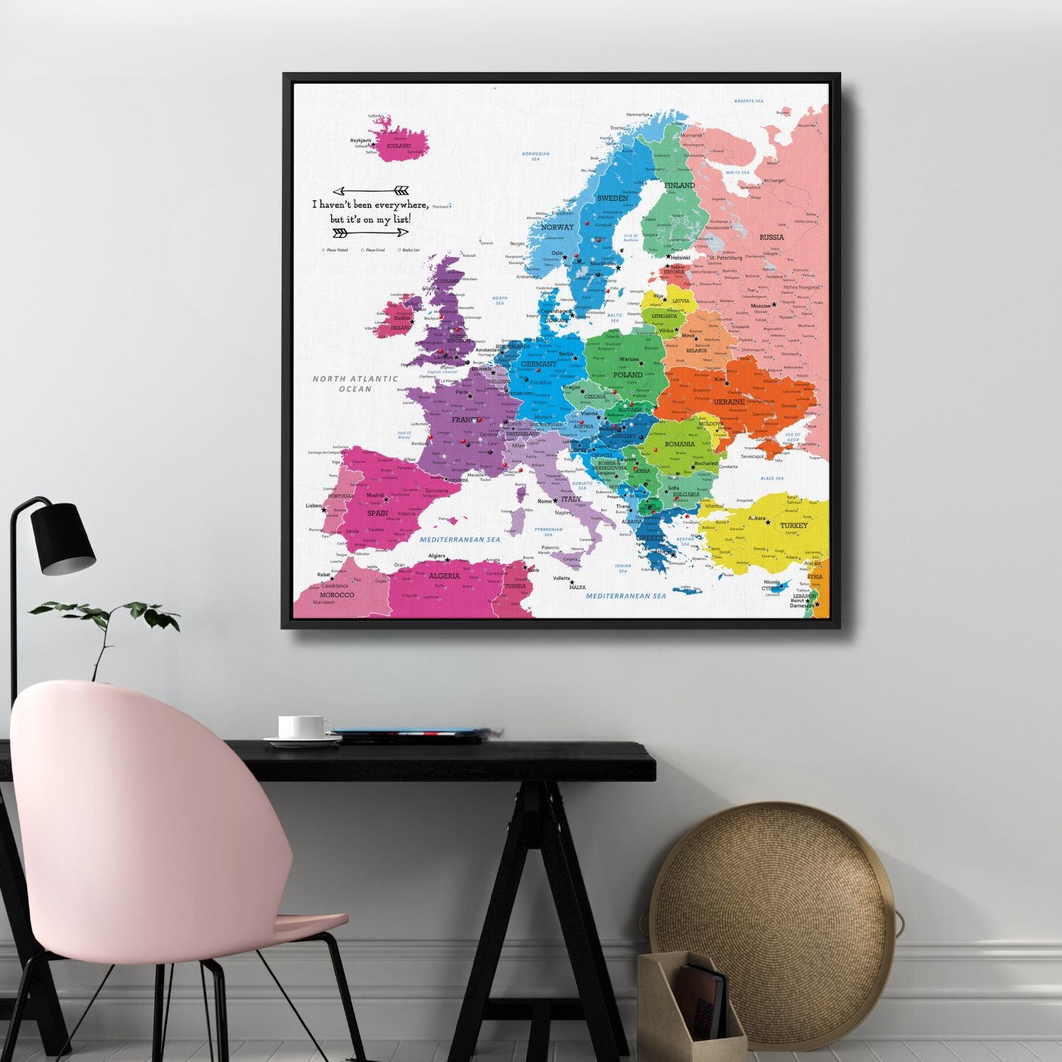Colorful Europe travel map canvas with pins displayed above modern desk workspace