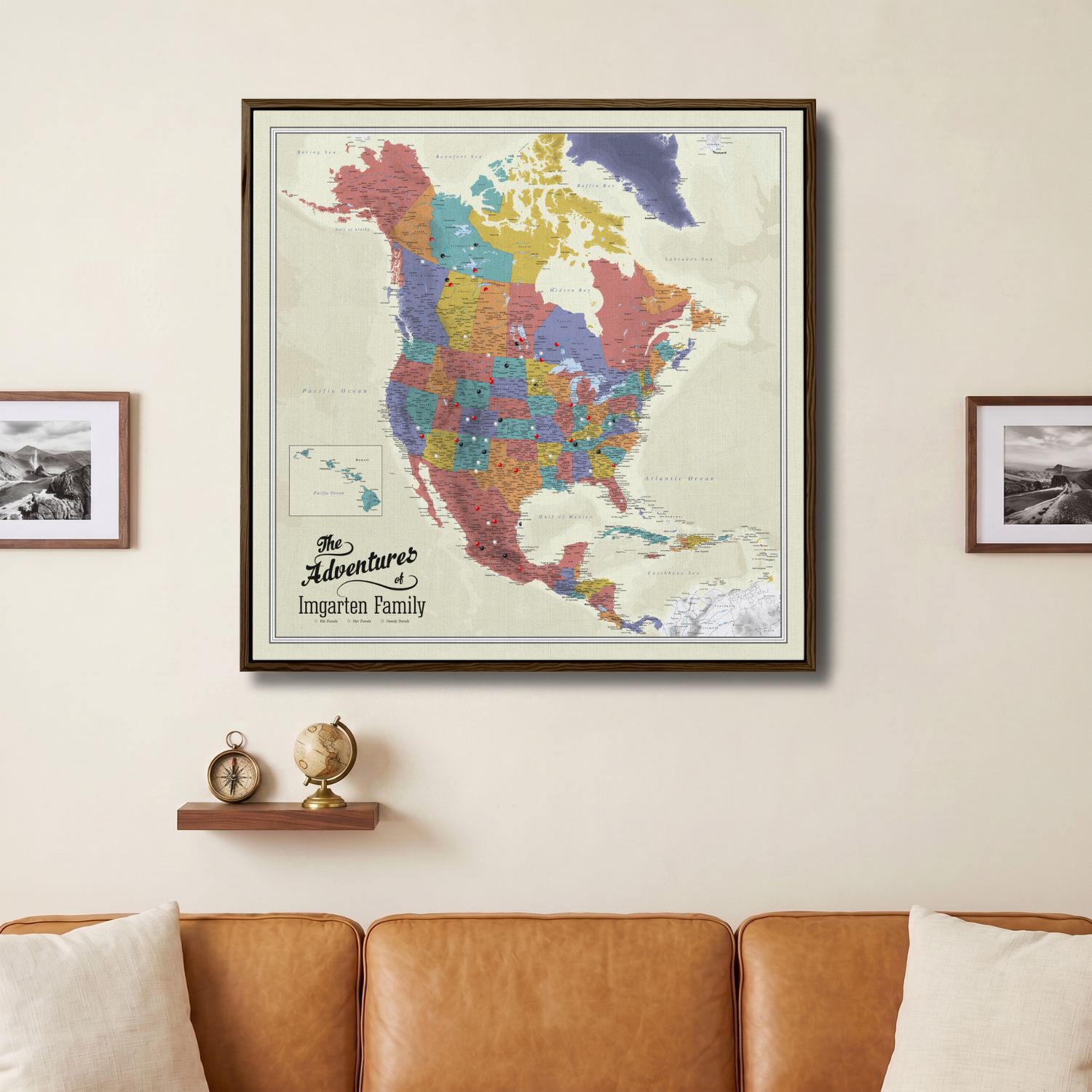 Personalized North America push pin travel map canvas framed in dark wood above leather sofa