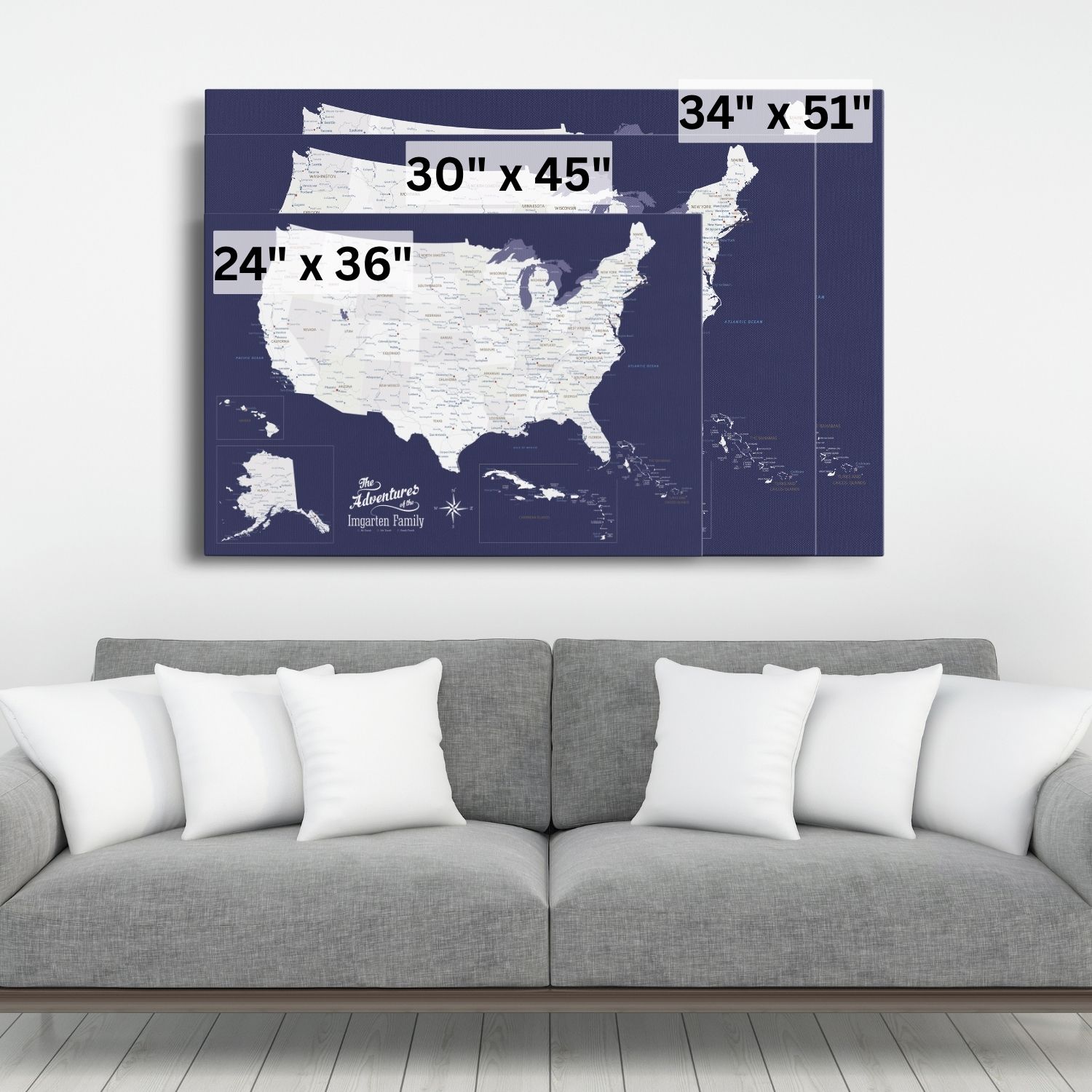 Navy blue USA and Caribbean canvas travel map displayed above gray sofa showing three size options 24x36 30x45 34x51