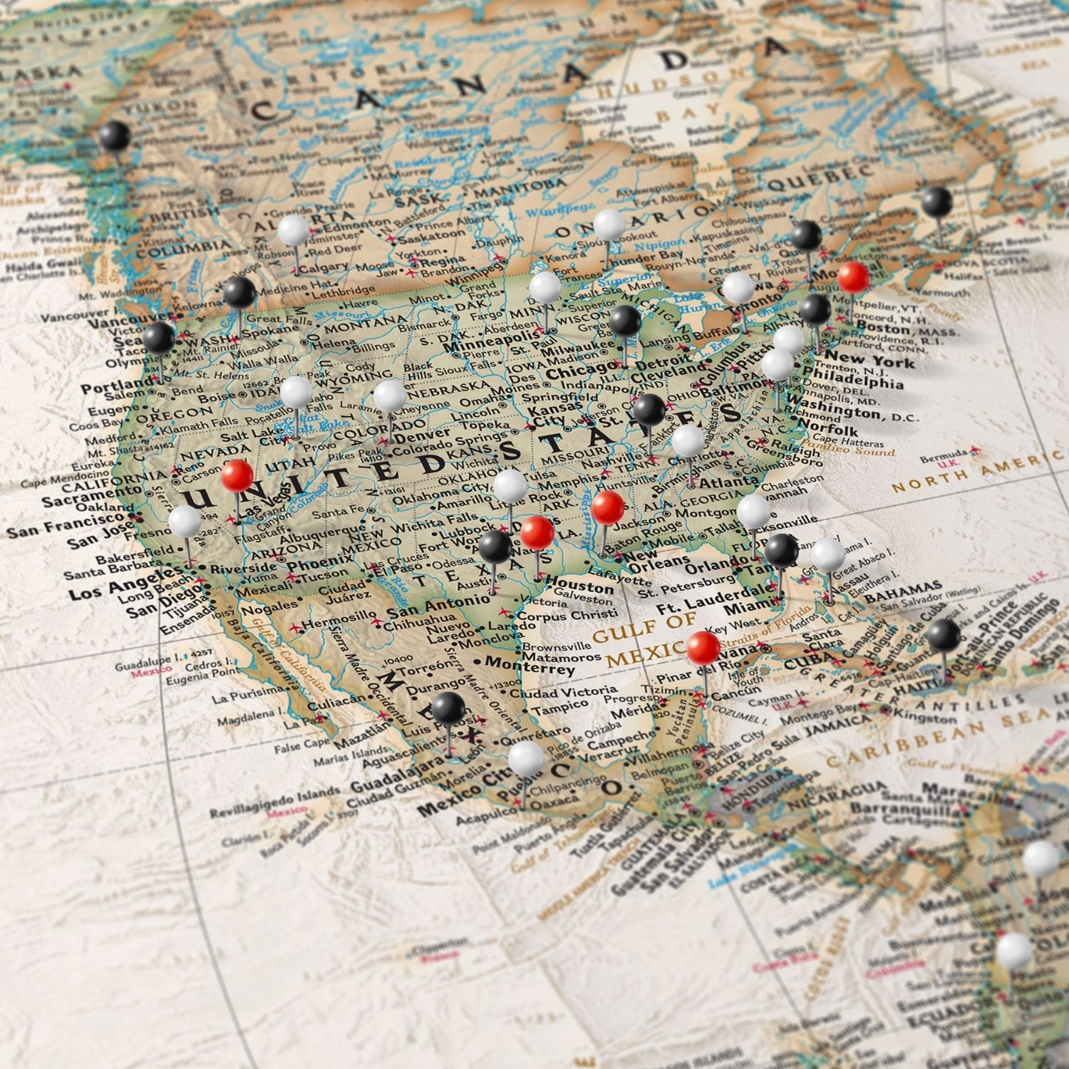 Executive World Travel Map canvas close-up showing USA with red black and white pins marking visited cities