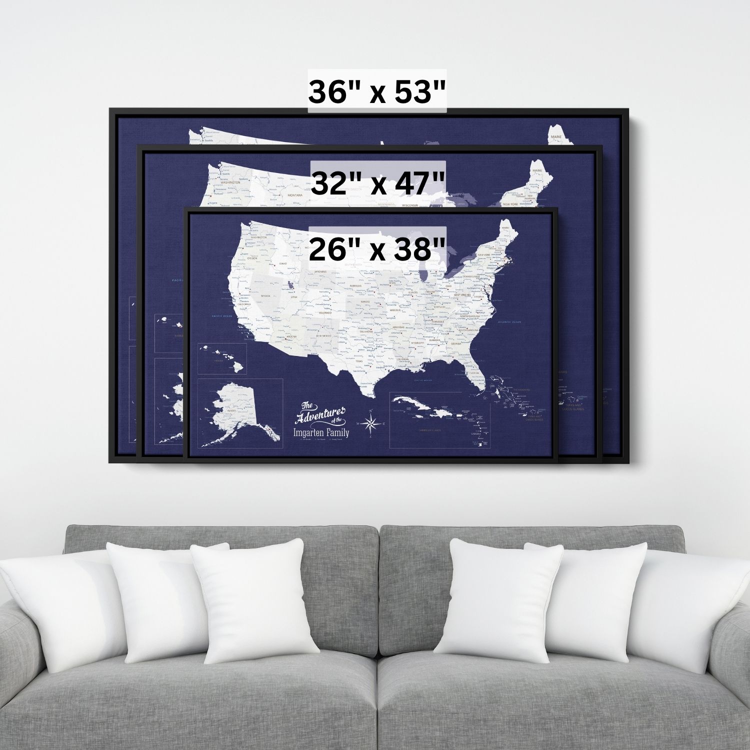 Three size options of navy blue USA Caribbean canvas travel map displayed above gray sofa