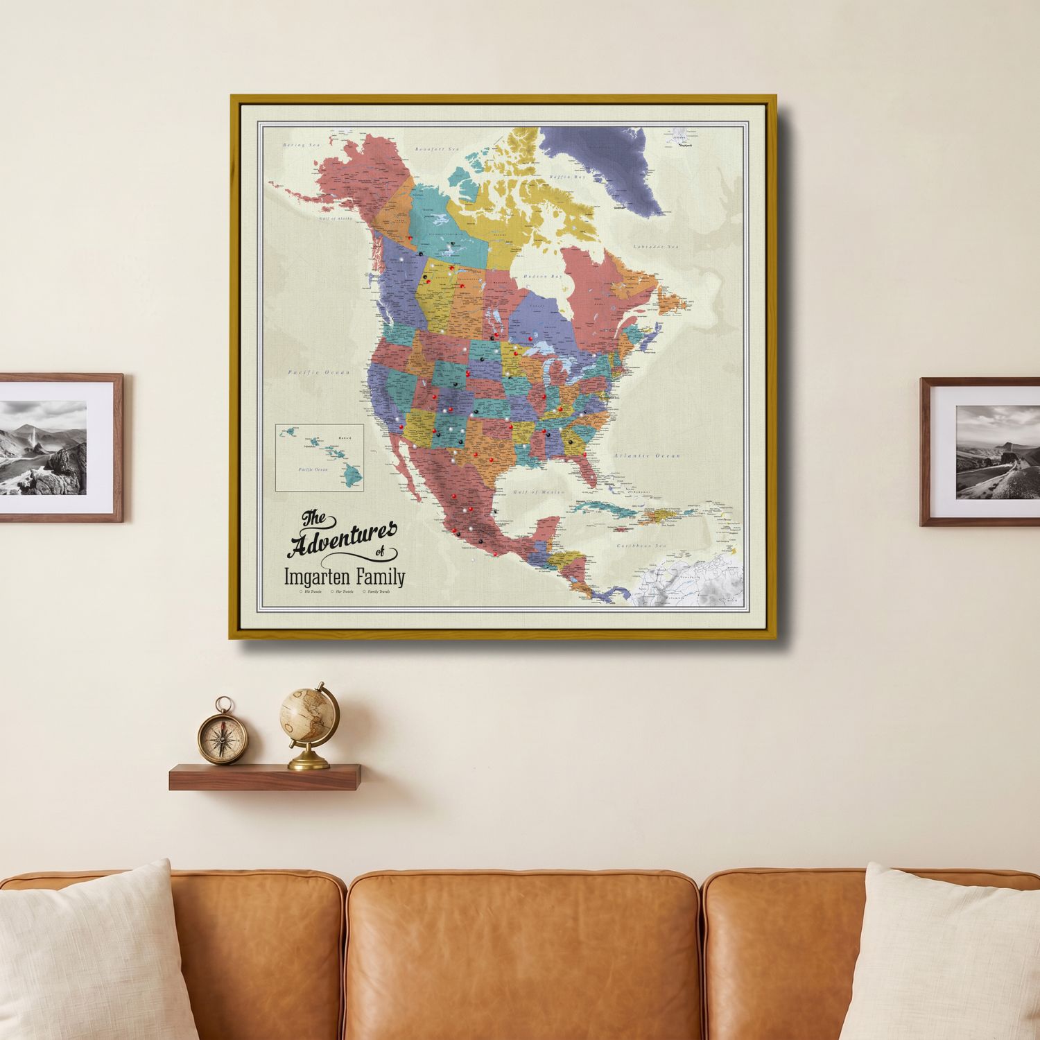 Personalized North America push pin travel map canvas in gold frame above leather sofa