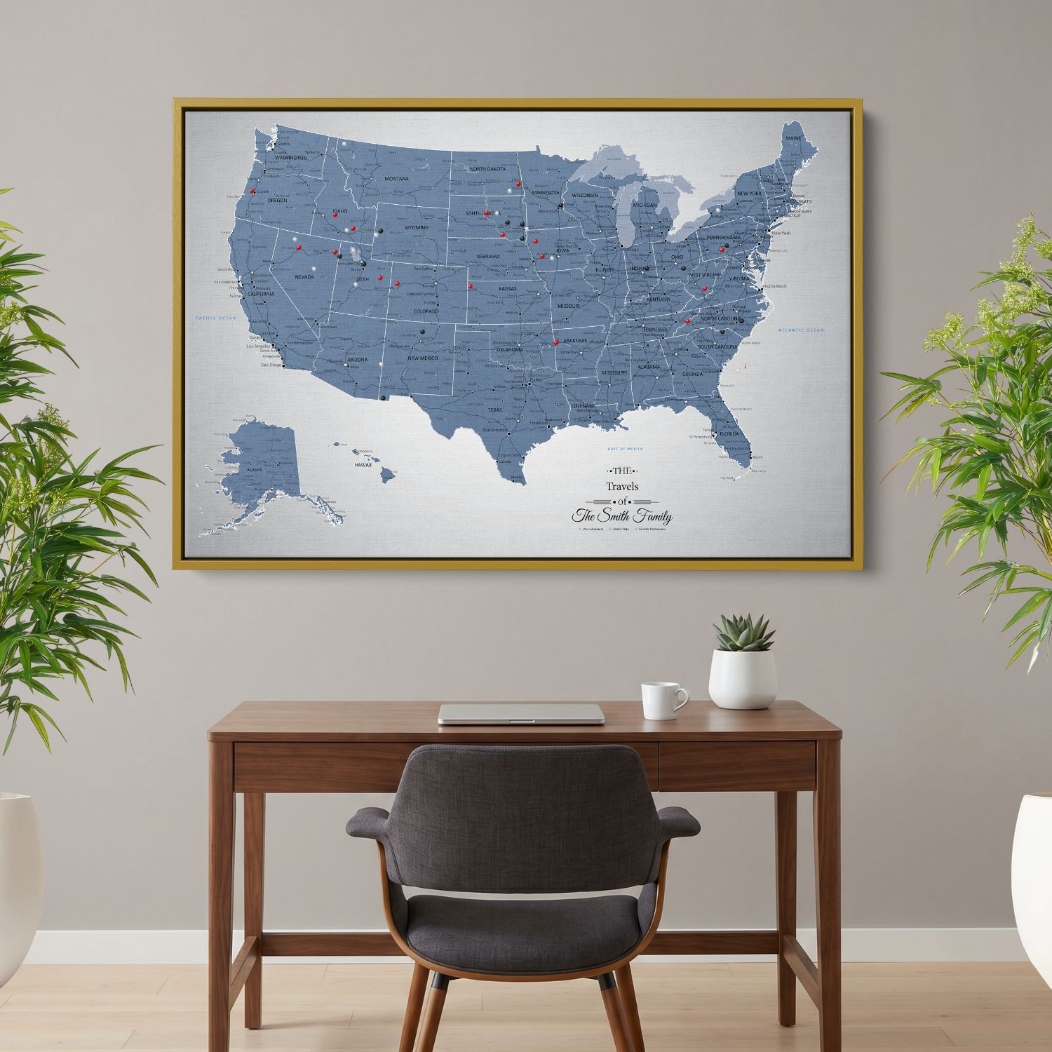 Blue Ice USA push pin travel map canvas in gold frame hanging above wooden desk in home office
