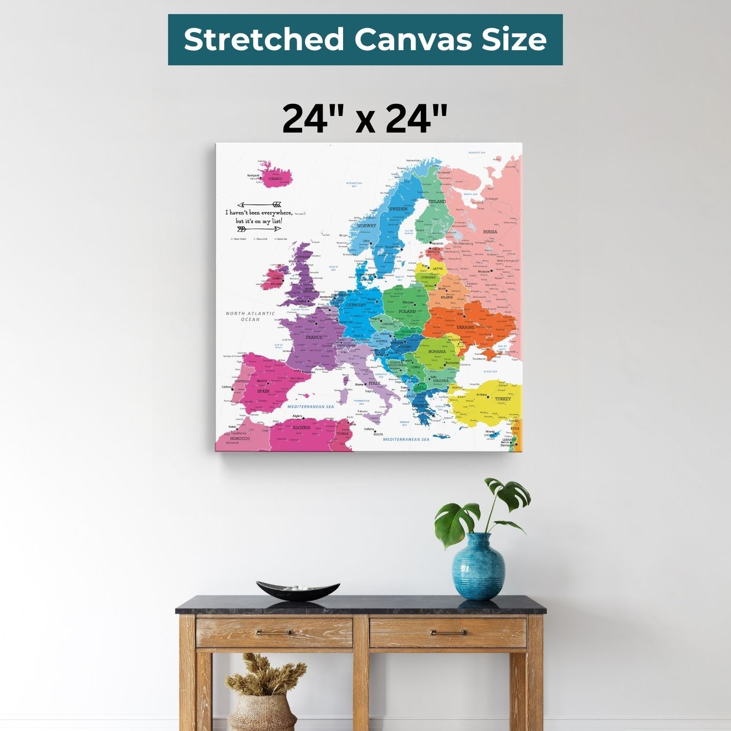 Colorful Europe travel map canvas 24x24 inches displayed above wooden console table