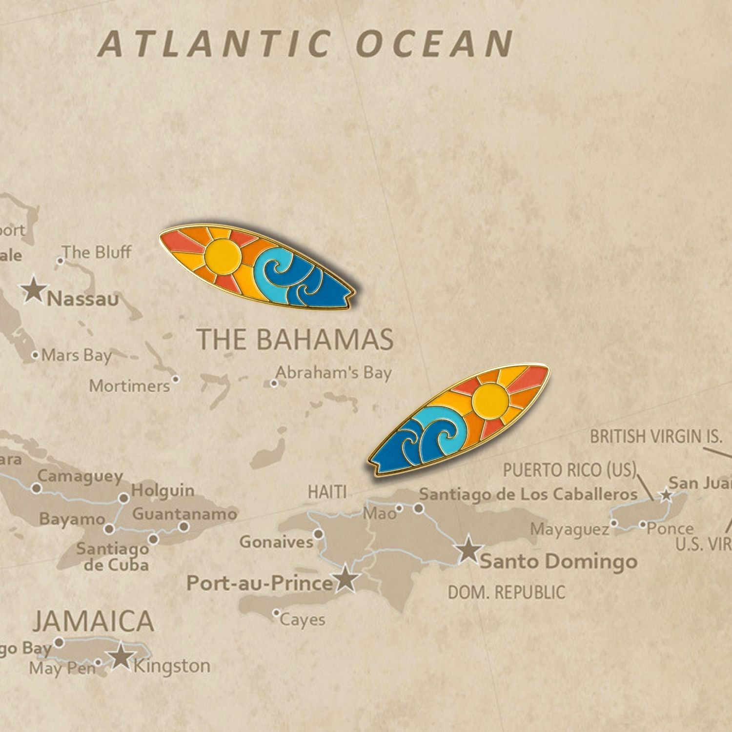 Two surfboard enamel push pins placed on vintage Atlantic Ocean map near Bahamas