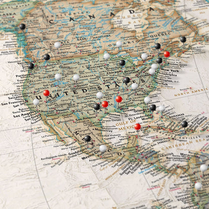 Executive World Travel Map canvas close-up showing USA with red black and white pins marking visited cities