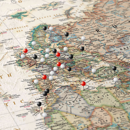 Executive World Travel Map canvas close-up showing Europe with red black and white pins marking visited cities