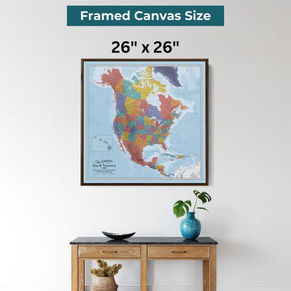 26x26 inch framed canvas North America travel map with colorful regions displayed above wooden console table