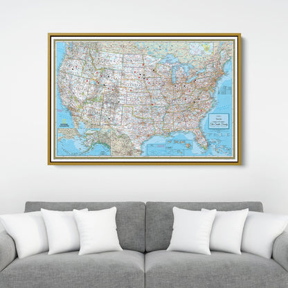 Personalized Classic USA National Geographic travel pin map in gold frame hanging above gray sofa