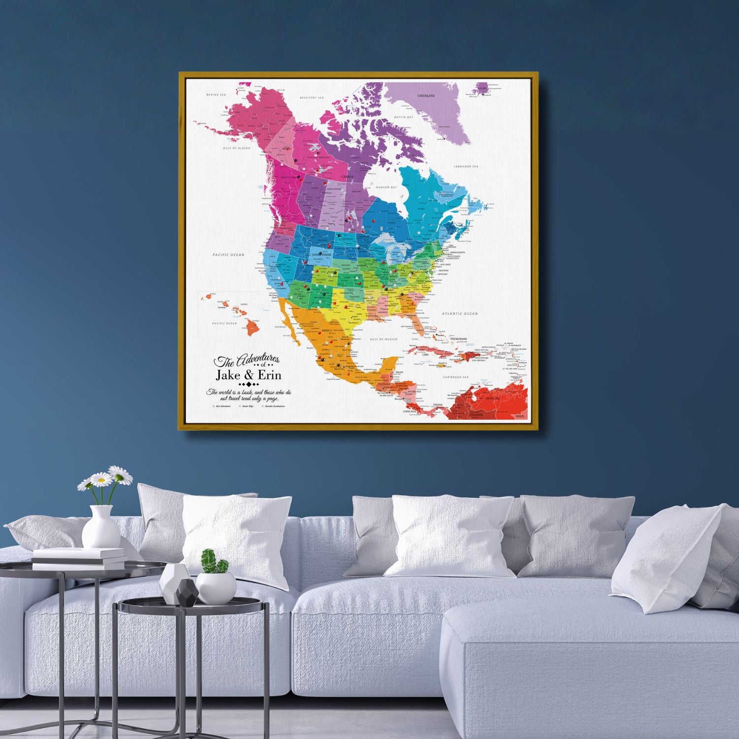 Colorful North America travel map canvas in gold frame hanging above modern white sofa