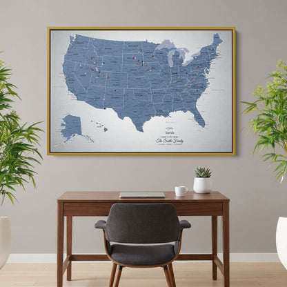 Blue Ice USA push pin travel map canvas in gold frame hanging above wooden desk in home office