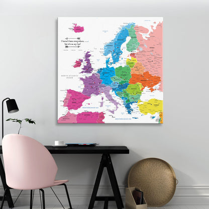Colorful Europe travel push pin map canvas hanging above modern desk workspace