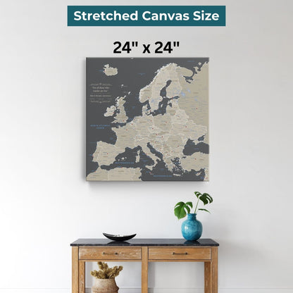 24x24 inch earth toned Europe travel map canvas displayed above wooden console table with blue vase