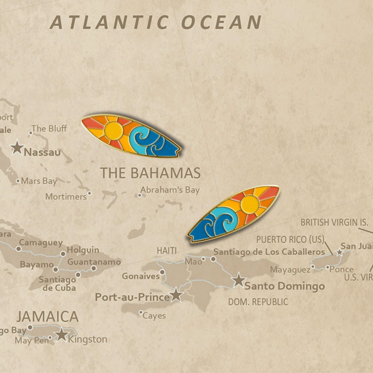 Two surfboard enamel push pins placed on vintage Atlantic Ocean map near Bahamas
