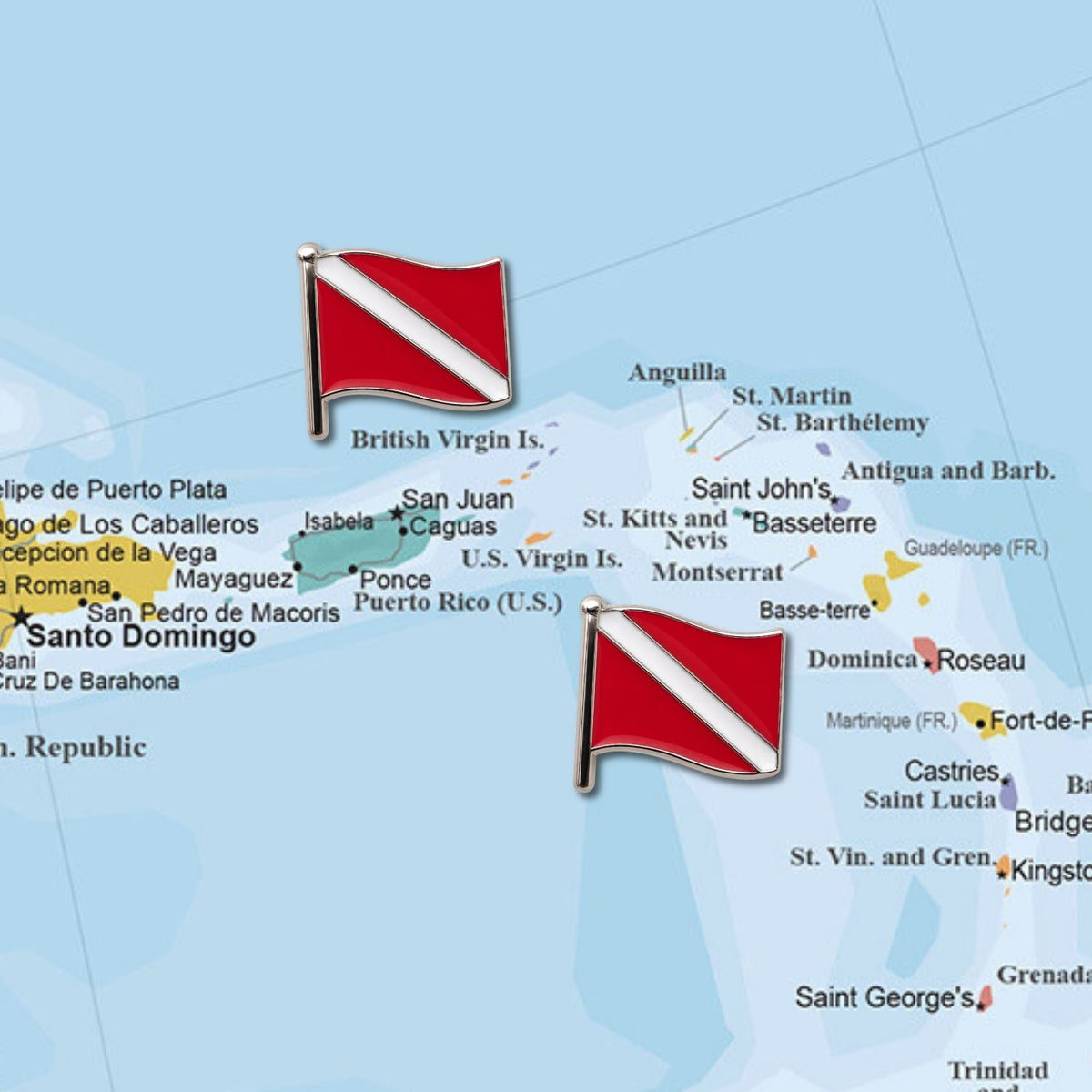 Two red white scuba dive flag enamel push pins placed on Caribbean map marking dive destinations