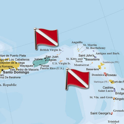Two red white scuba dive flag enamel push pins placed on Caribbean map marking dive destinations