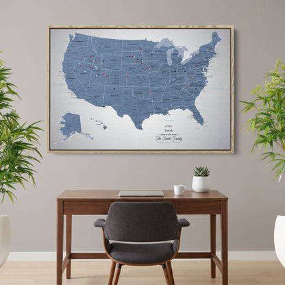 Personalized blue ice USA push pin travel map canvas in wood frame hanging above home office desk
