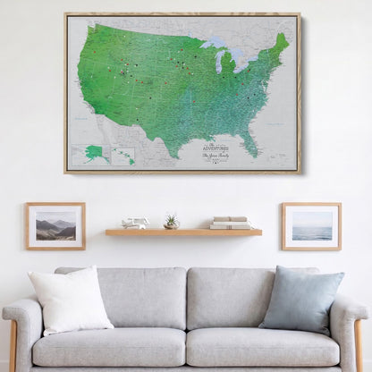 Enchanting Emerald watercolor USA travel map canvas with red and black pins displayed above living room sofa