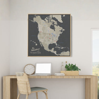 Personalized earth toned North America travel map with push pins in natural wood frame above desk