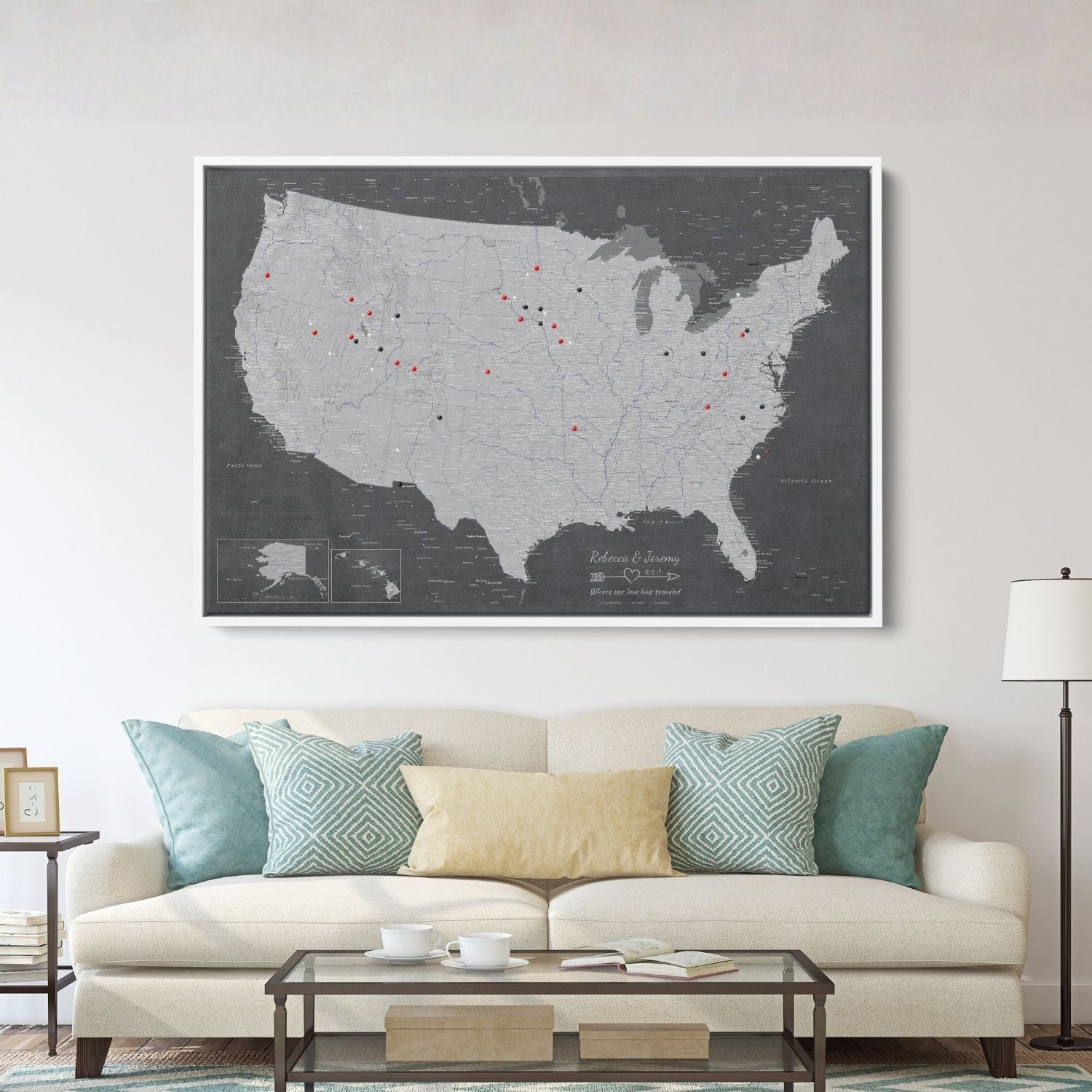 Stormy Dreams USA travel map with pins displayed above living room sofa in white frame