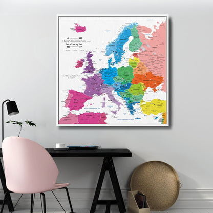 Colorful Europe travel map canvas with pins displayed above modern home office desk