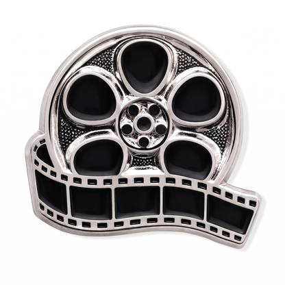 Silver and black enamel movie film reel lapel pin with unspooling filmstrip detail